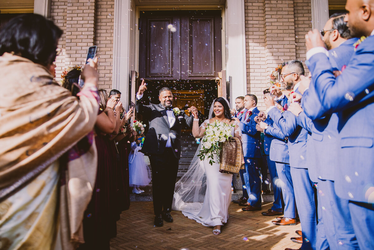 Indian christian malayali couple exit the immaculate conception roman catholic church with a bubble exit