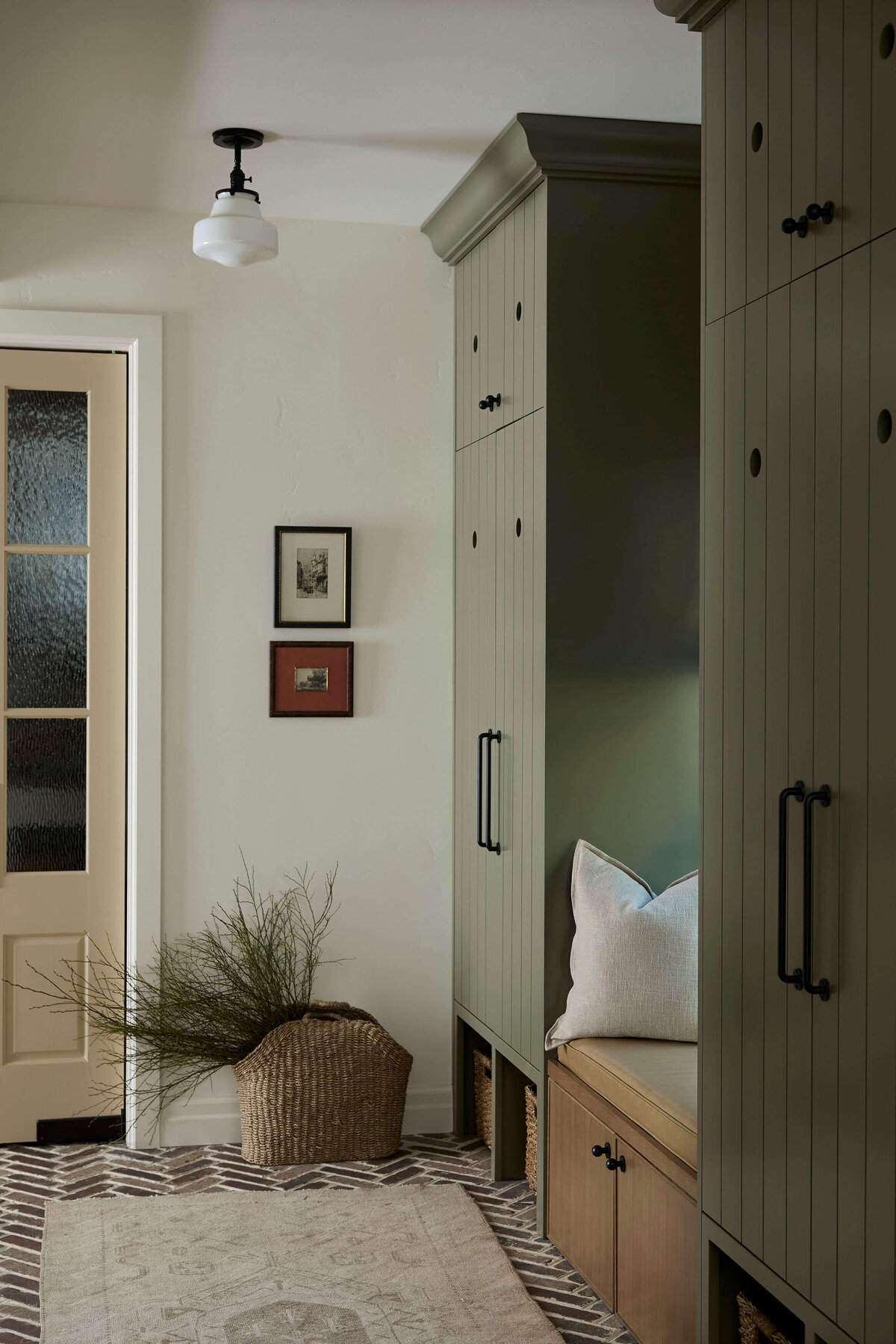 mudroom-with-green-cabinets-and-brick-flooring