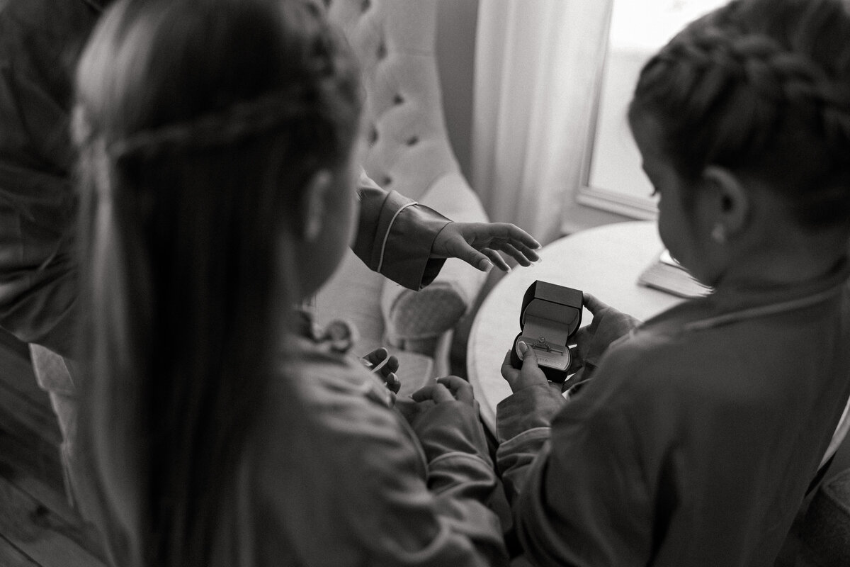 Flower girls being curious with the wedding rings at an intimate wedding celebration with Jamie Tobin Photography capturing these moments