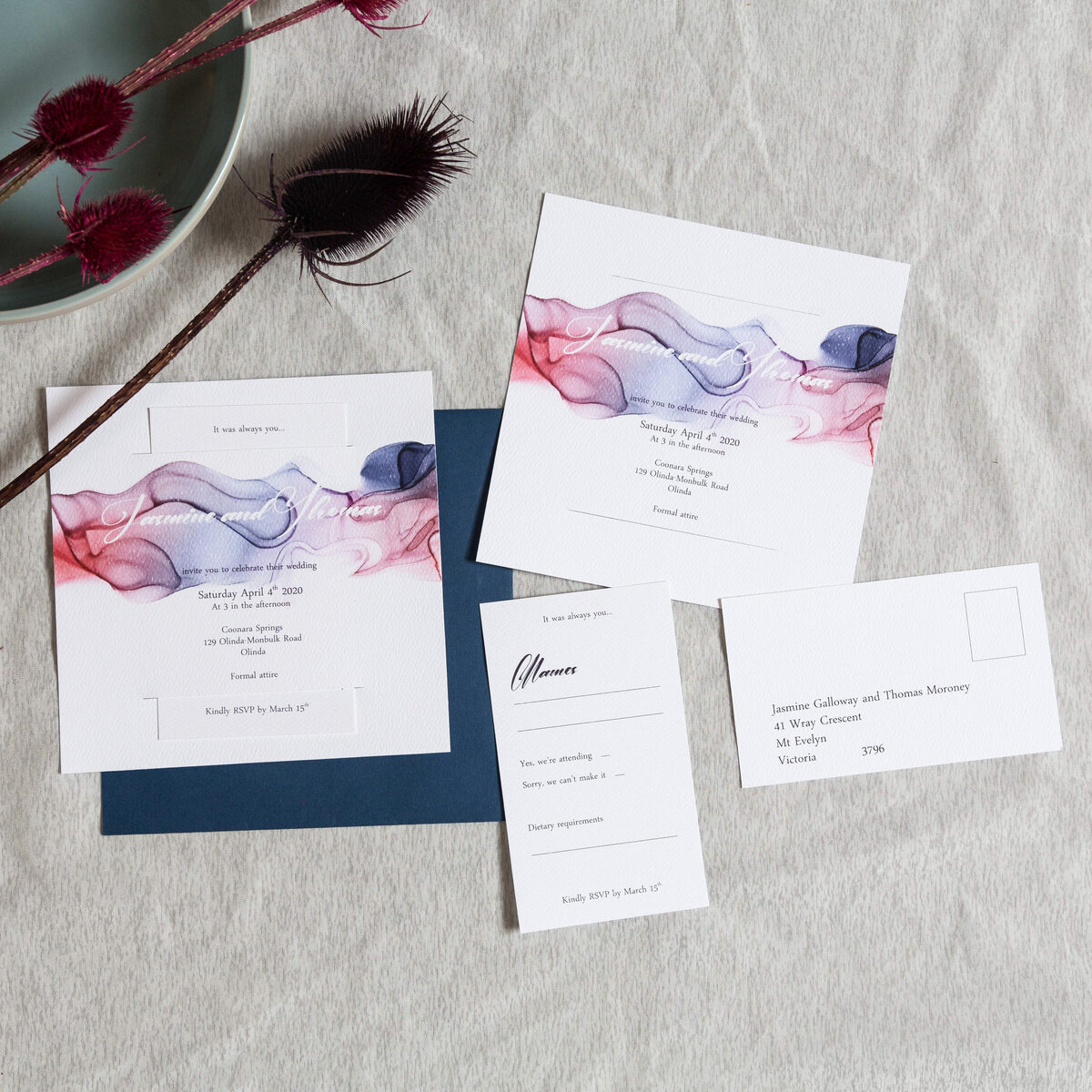 Blue wedding invitation with an ink design and an RSVP card that sits within the invitation