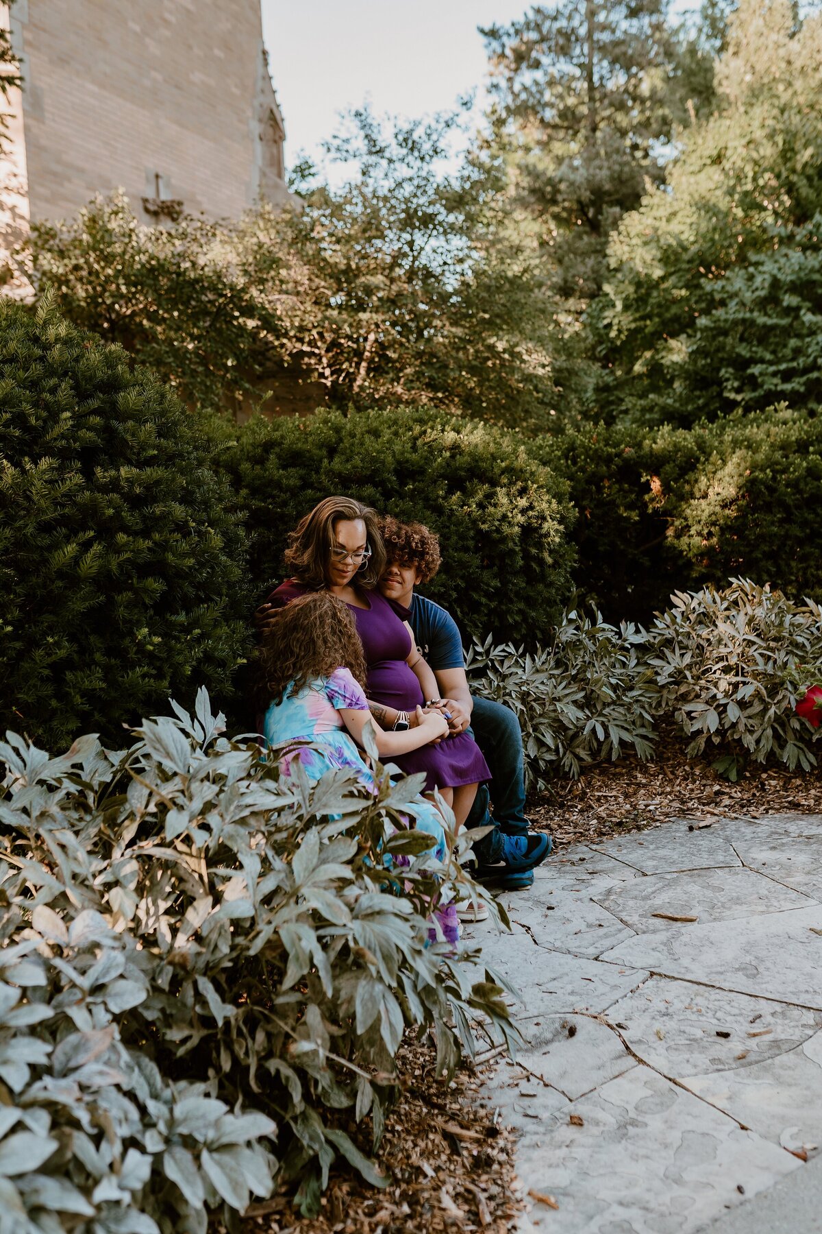 Candid-family-moment-garden-bench-Iowa-State-University-Ames-iowa-Storyteller-Collective-Photo-Co