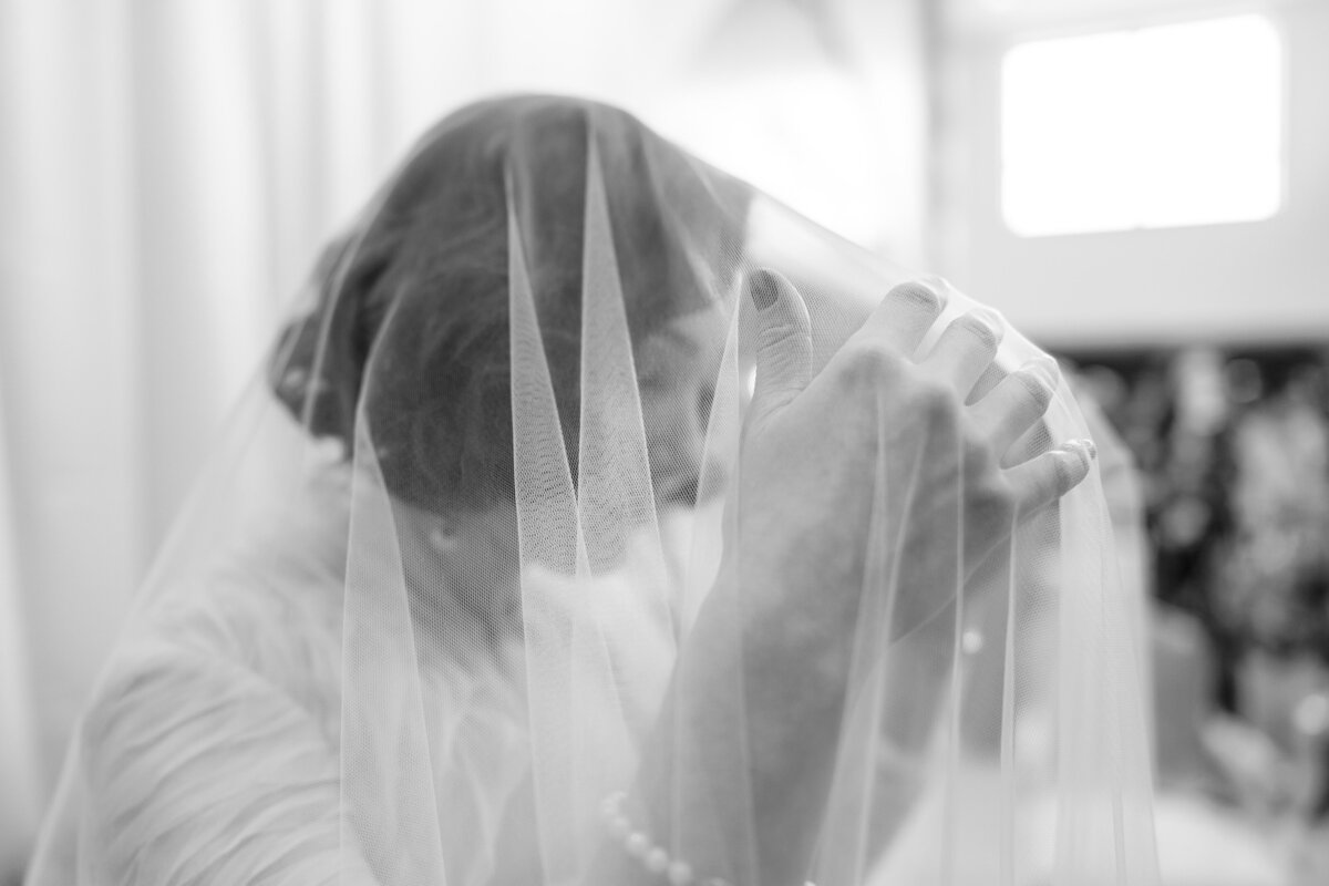 bride-adjusting-veil-wedding