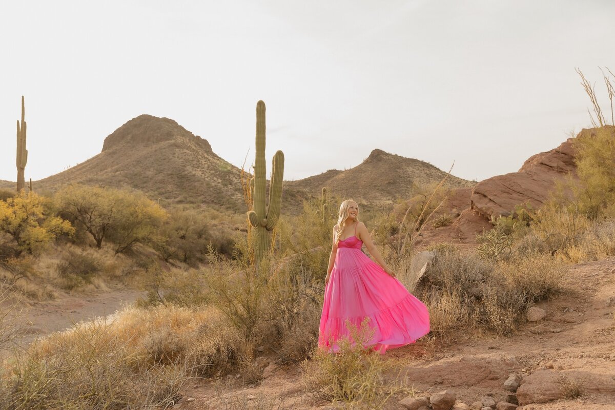 girl poses in arizona desert for senior photos