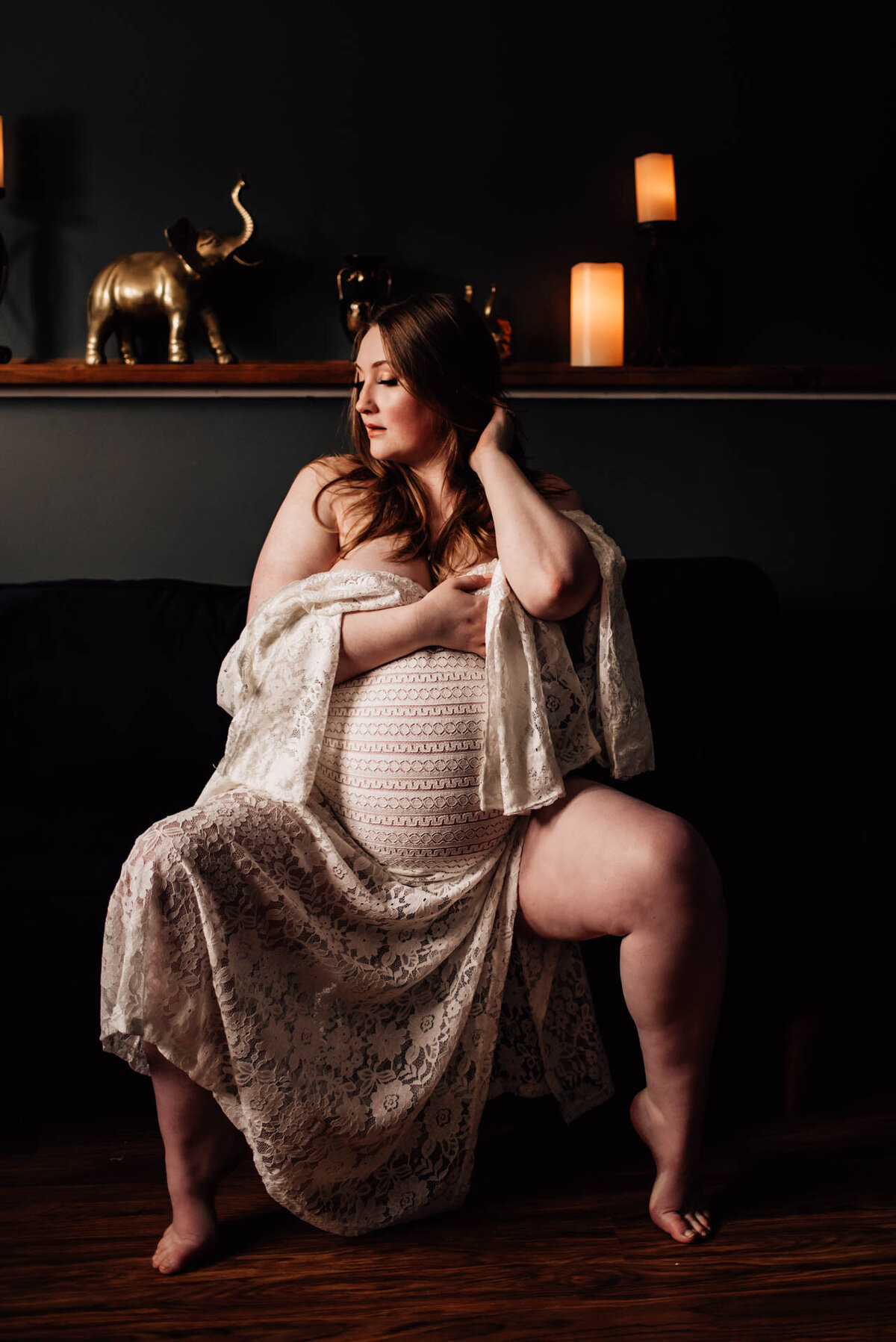 woman wearing white lace gown for ottawa maternity boudoir photoshoot
