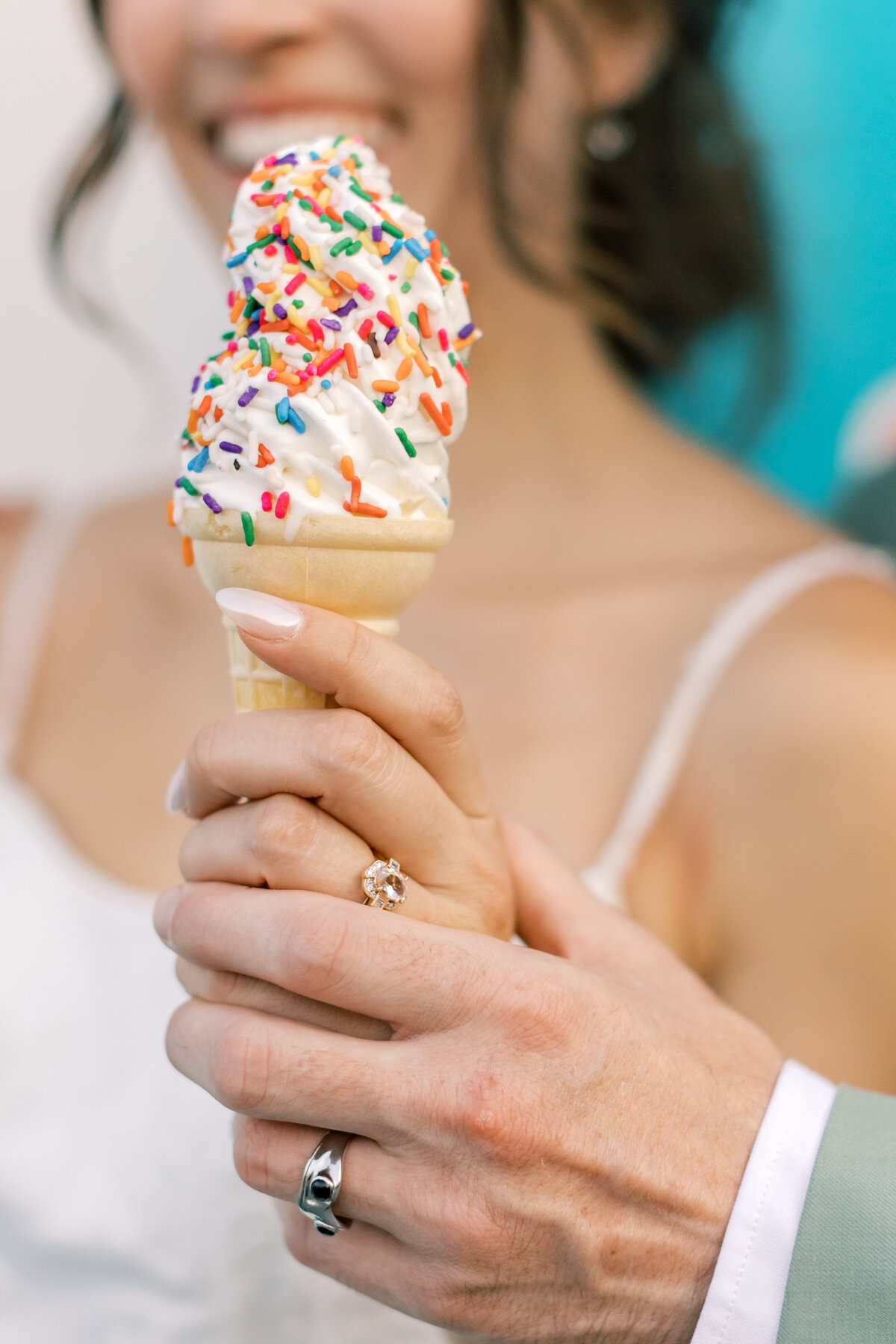 Brendan and Sara sharing ice cream cone by vintage truck outside Fetewell wedding venue in Baltimore.