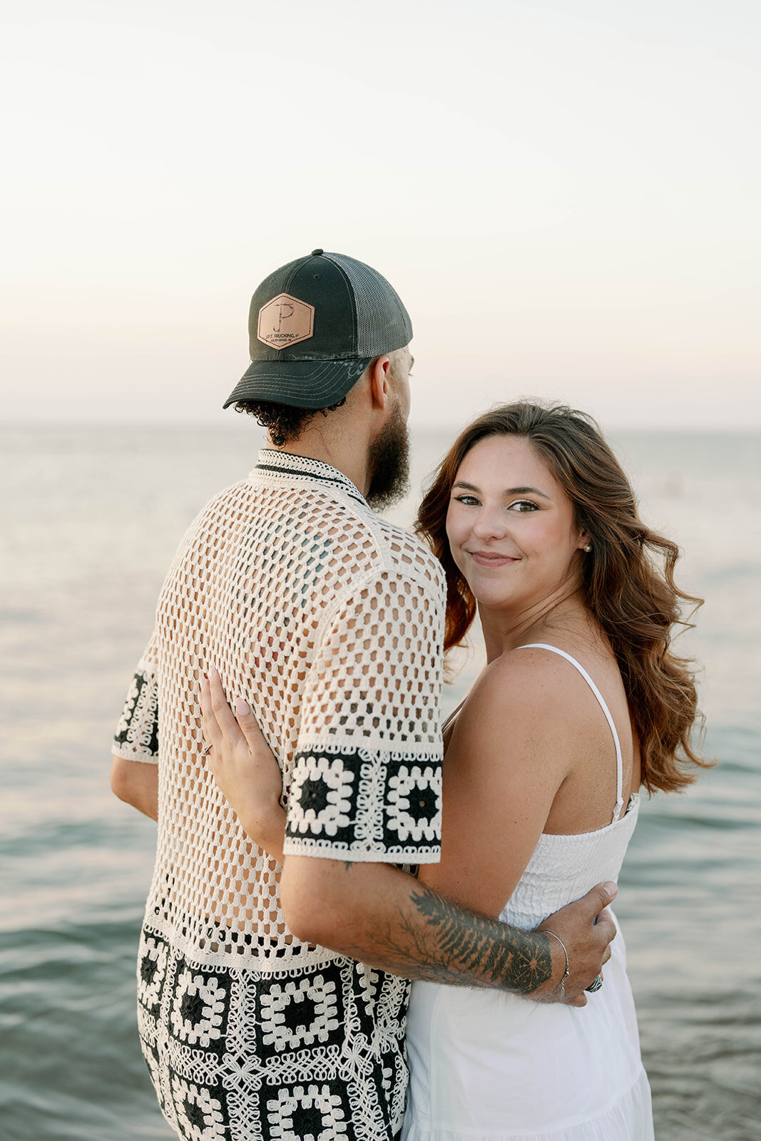 Close-up of couple holding hands during sunset beach engagement photos on Lake Michigan