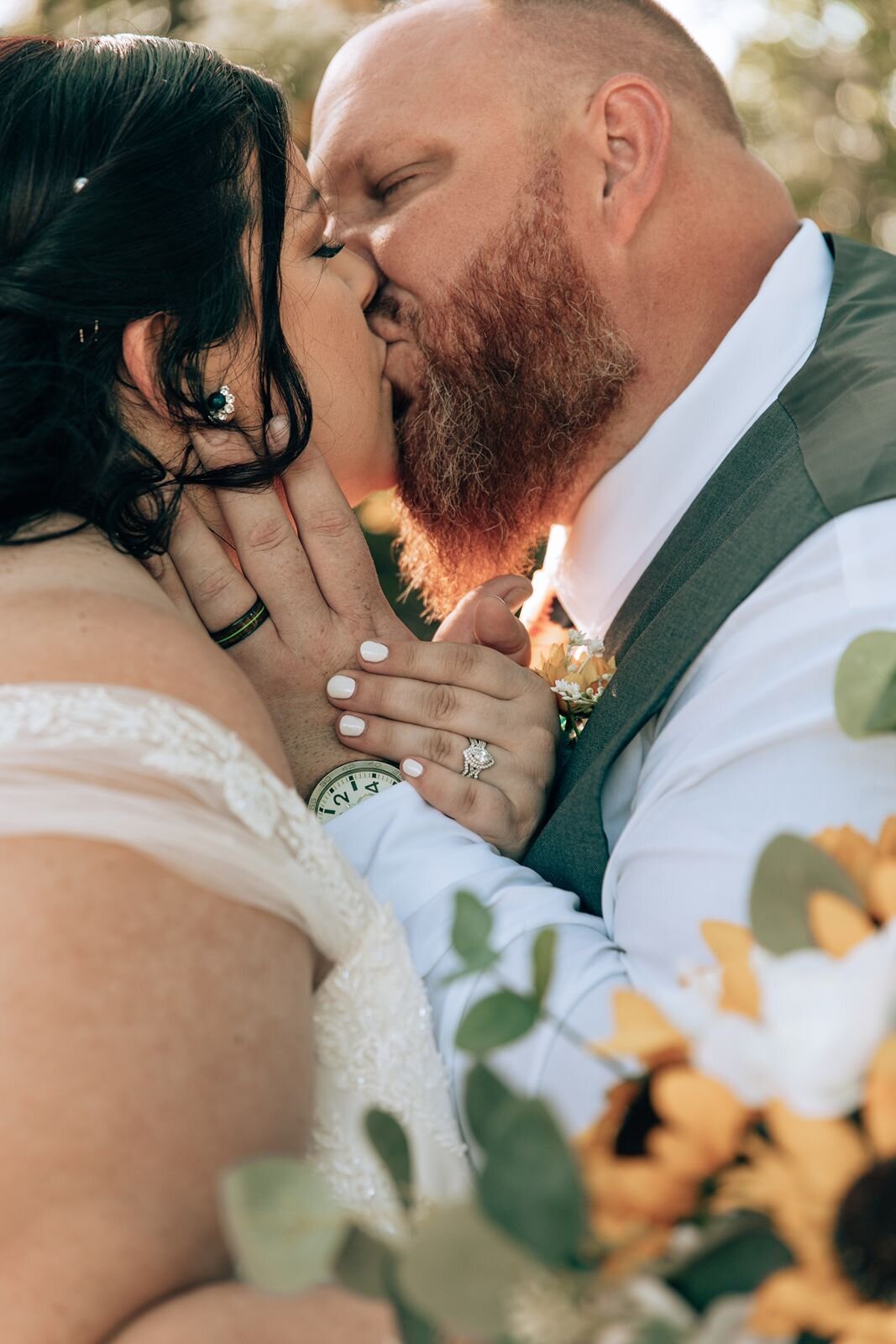 couple kiss during bride and groom portraits