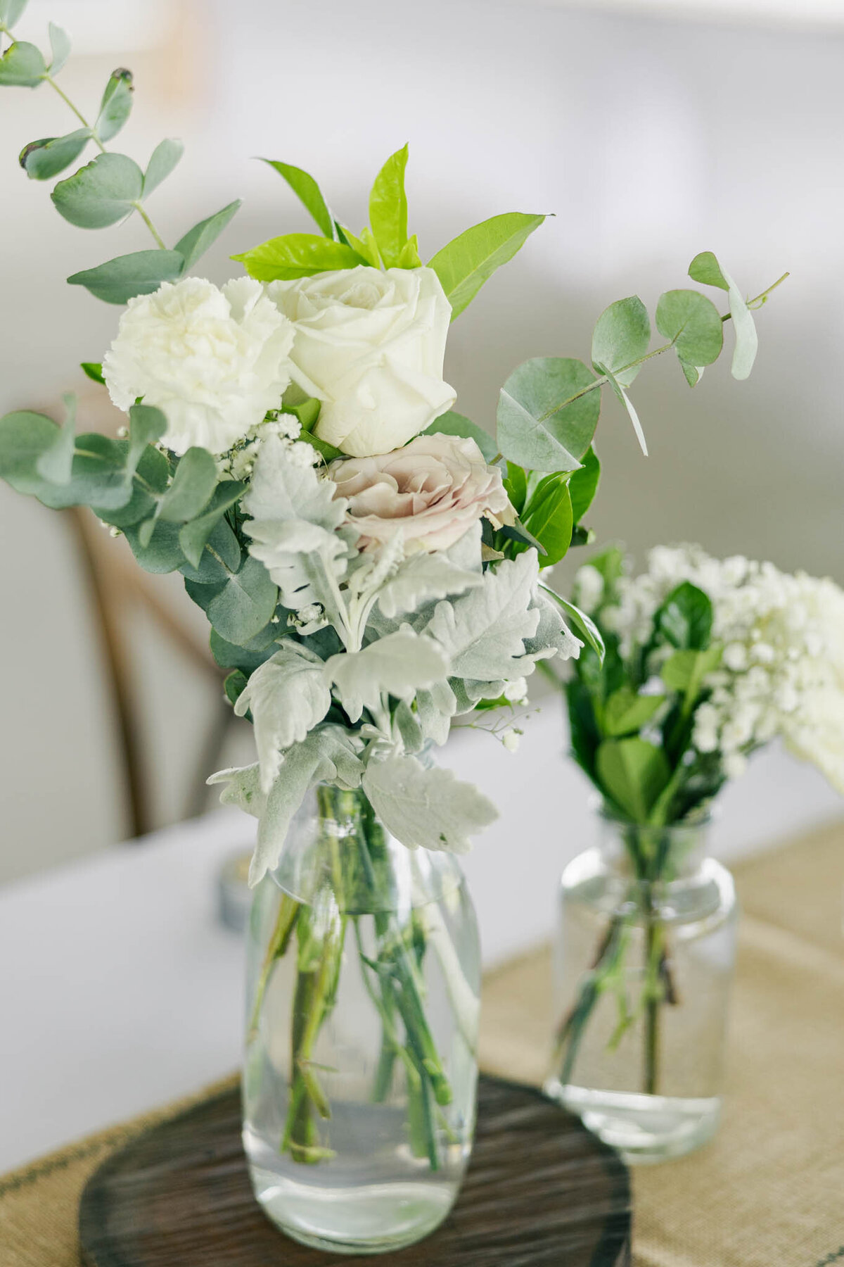Fresh roses as wedding centrepieces on tables