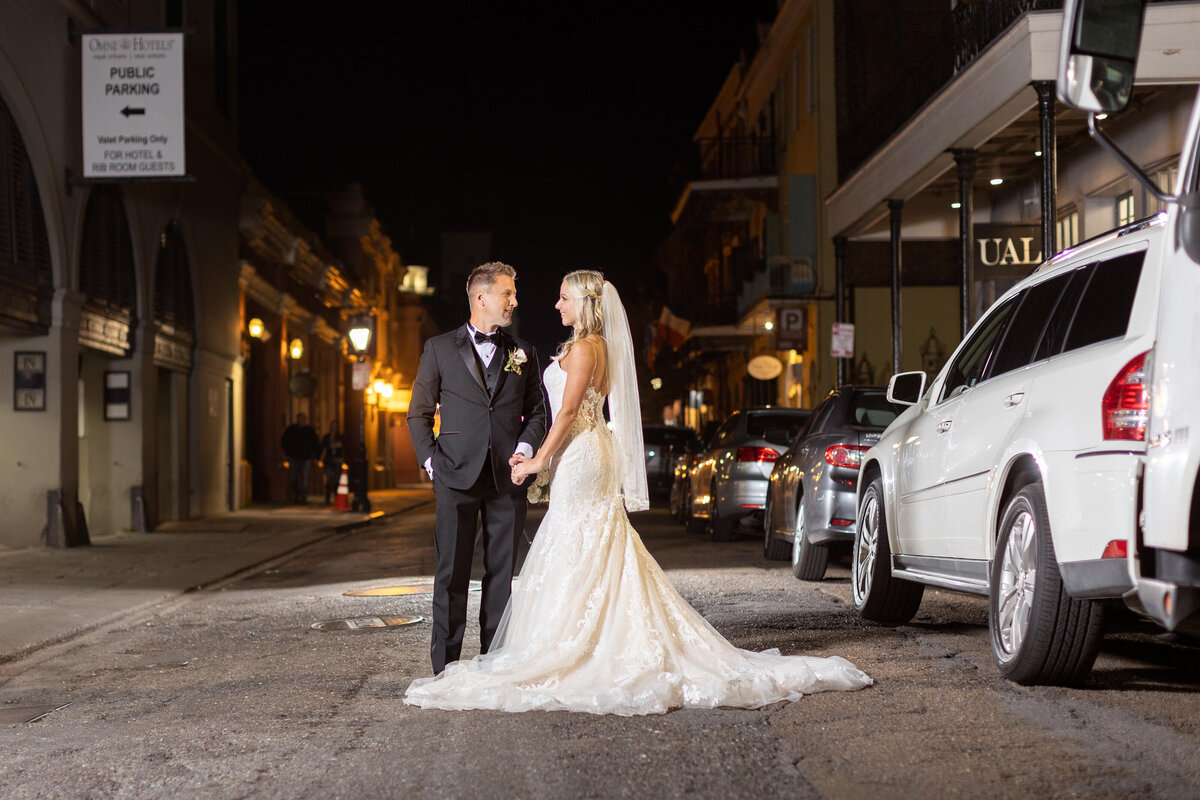The couple poses in the middle of the street for their wedding day photos in New Orleans, Louisiana.