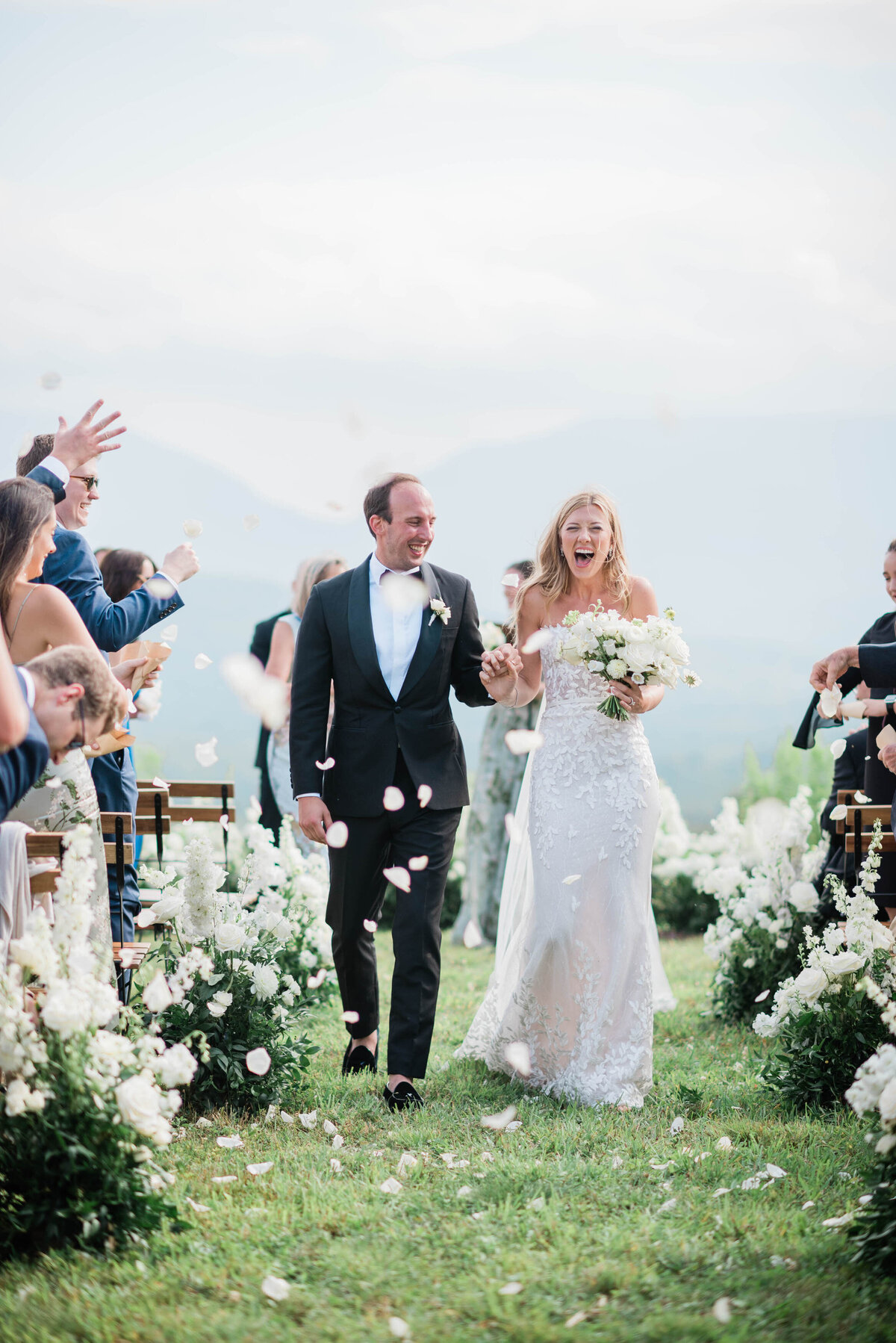 Bride and groom happily walk down the aisle