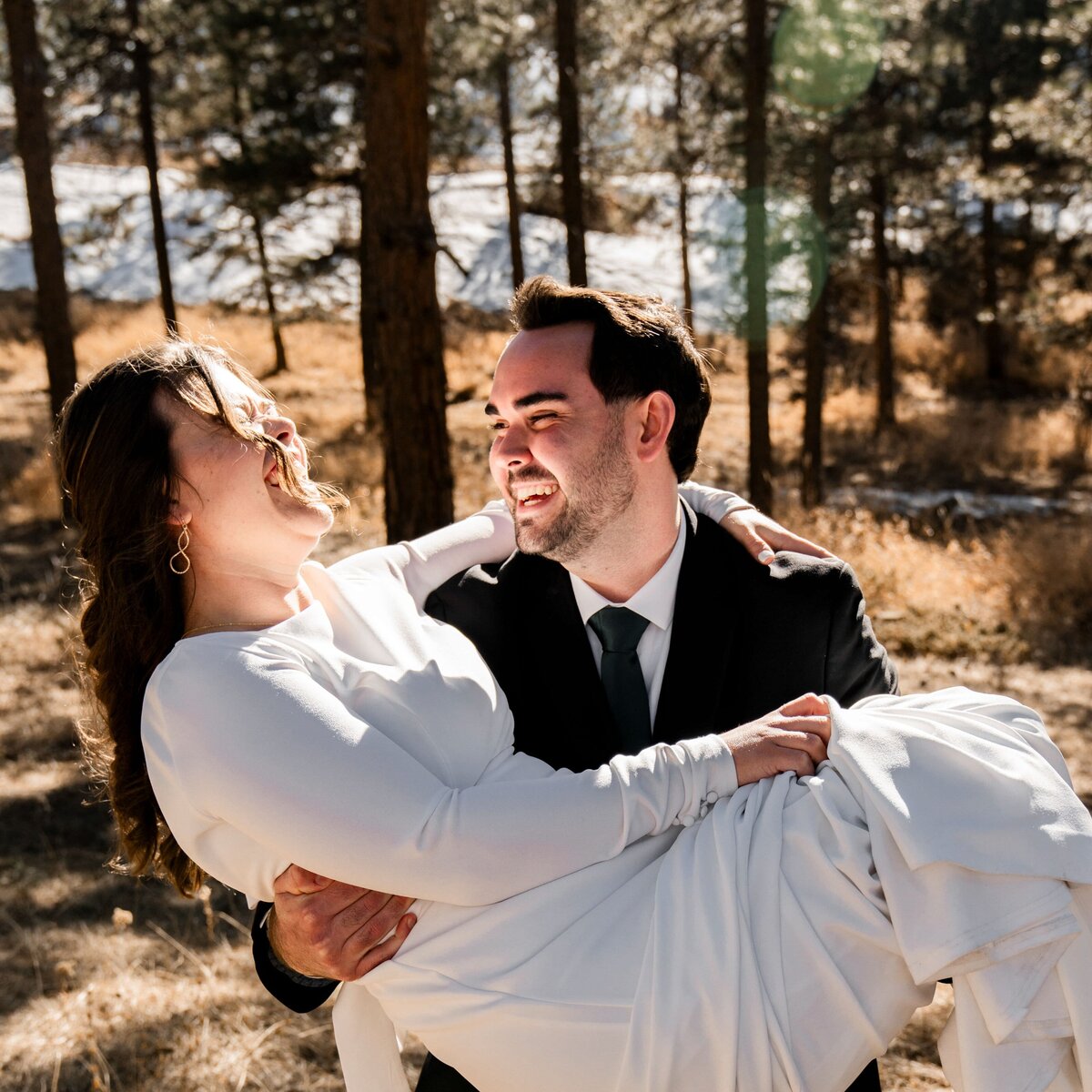 denver colorado wedding photographer - groom carrying bride in arms