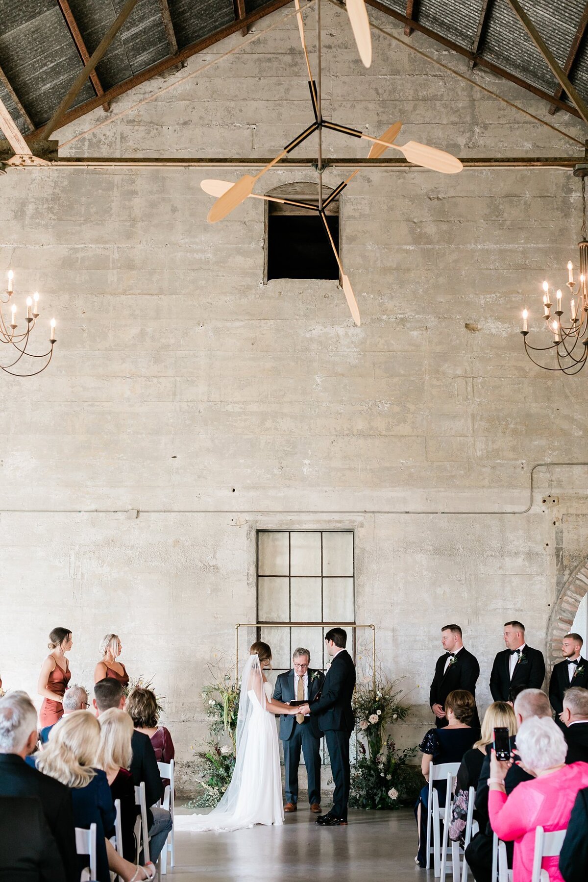 Wide vertical shot of bride and groom saying their vows at the alter at Olde Dobbin Station
