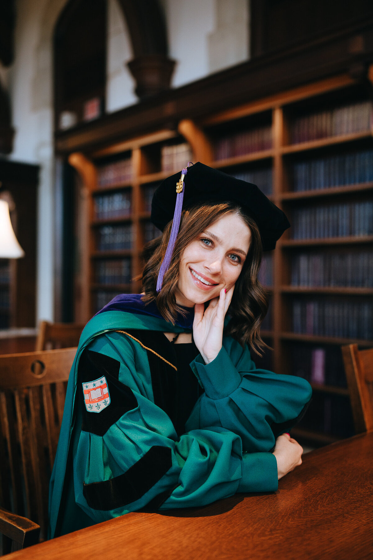 washu law graduate sitting at a table in the law library
