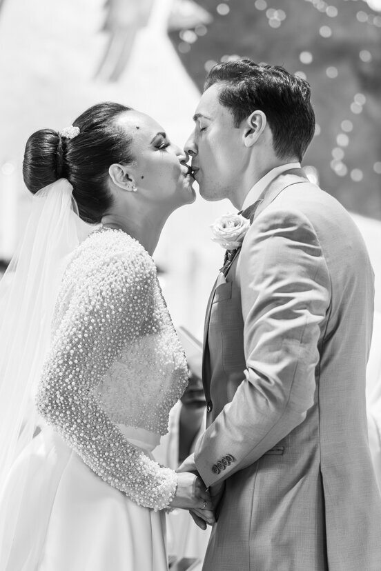 bride-and-groom-kissing-at-mary-star-of-the-sea-catholic-church-wedding