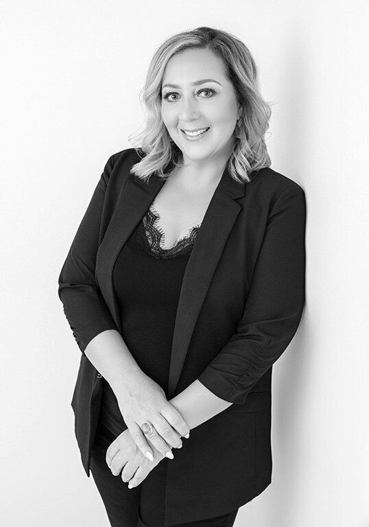 Headshot of realtor in black and white.
