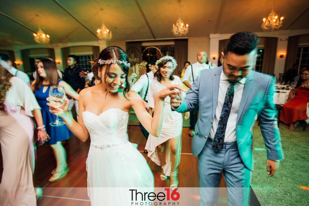 Bride and Groom do a line dance with wedding guests at their wedding reception