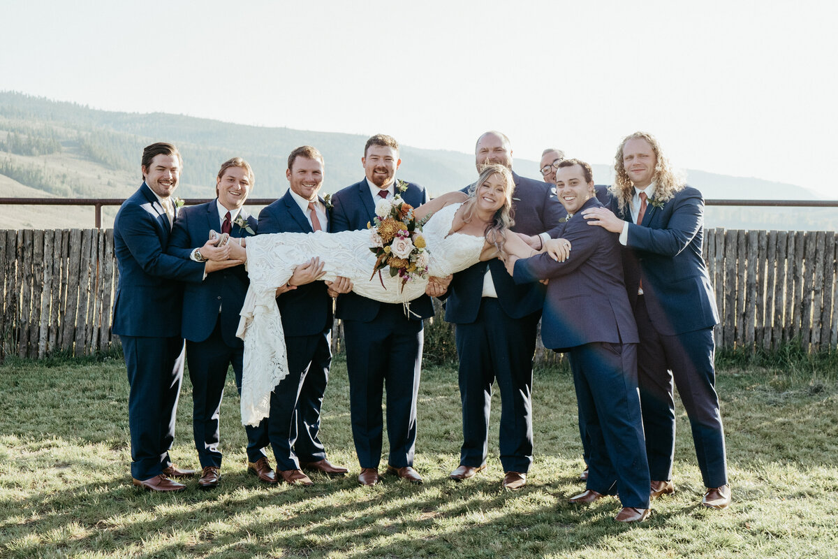 Groomsmen pose with the bride on her wedding day.