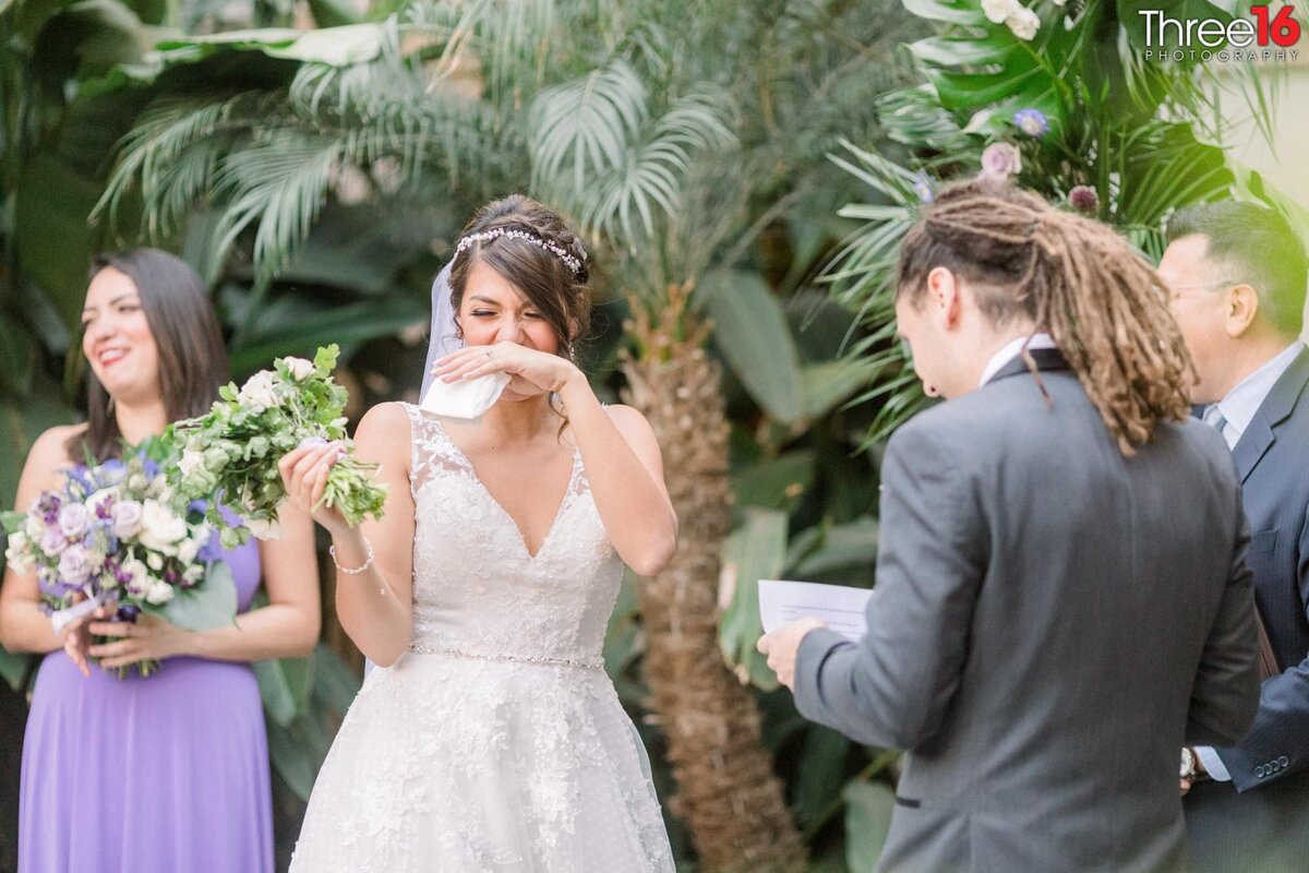 Bride sheds a tear as Groom reads his vow
