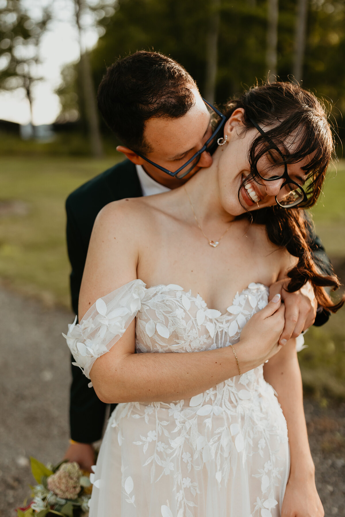 Groom Kissing Brides Neck and Holding Brides Bouquet