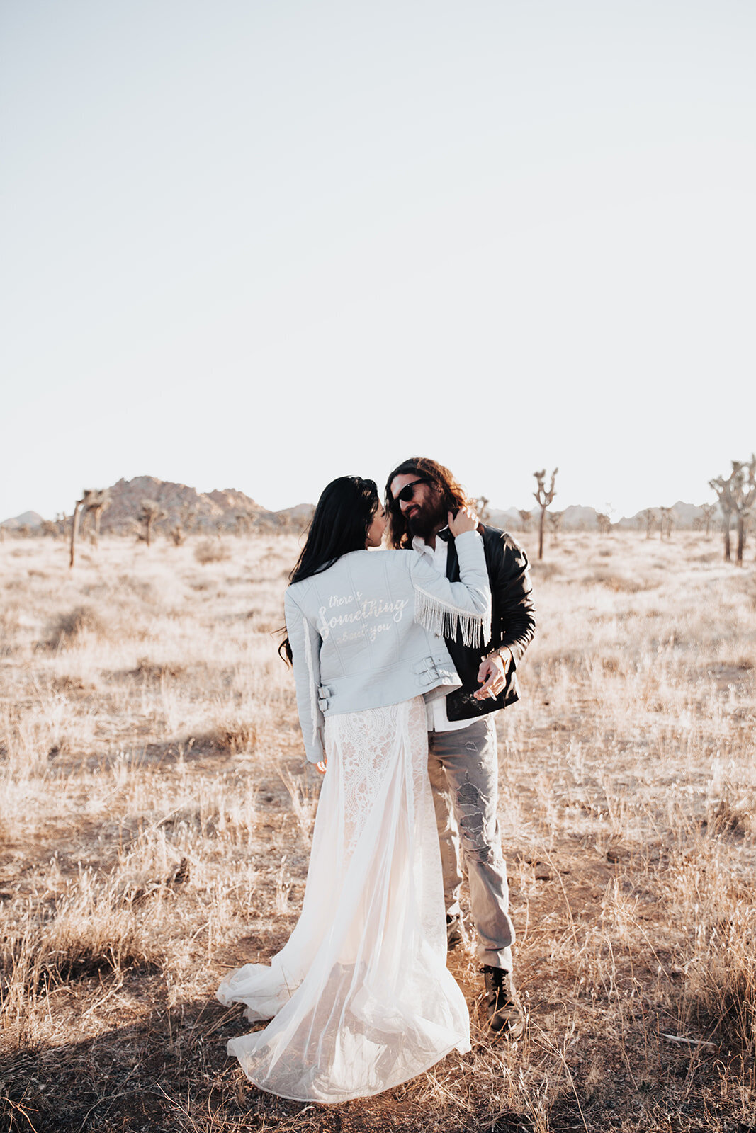 Casual wedding couple standing in Mojave Desert