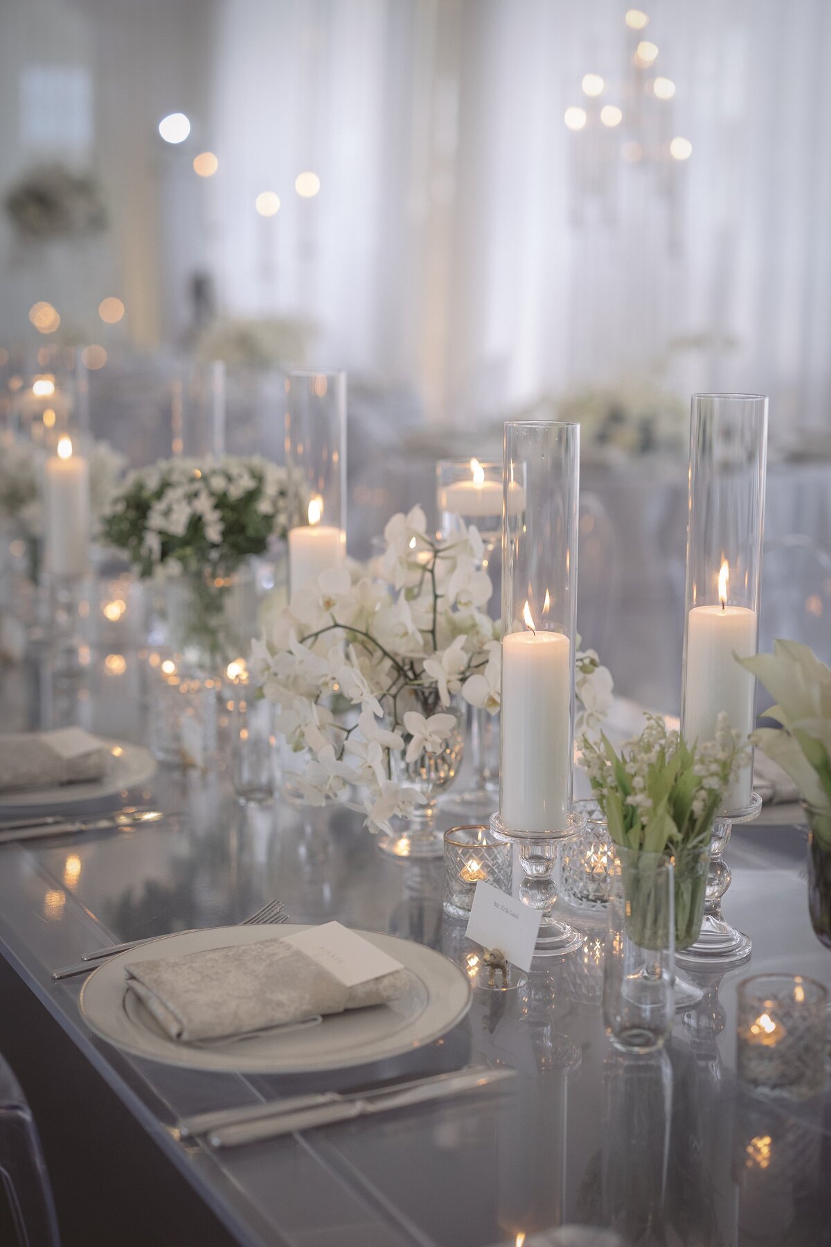 Candles on tabletop with flowers, wedding reception Newport.