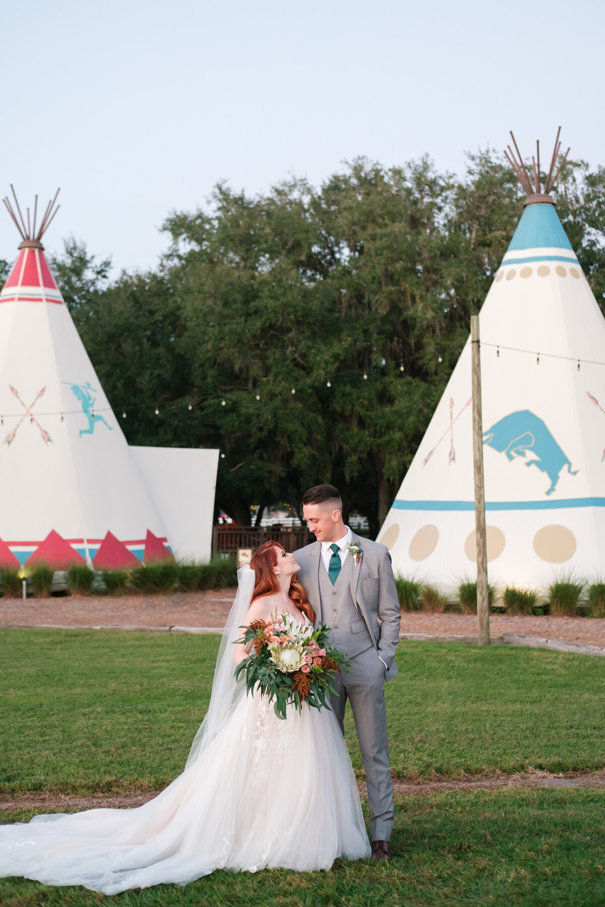 Bride and Groom pose in front of Teepee's after their wedding ceremony in rural Florida