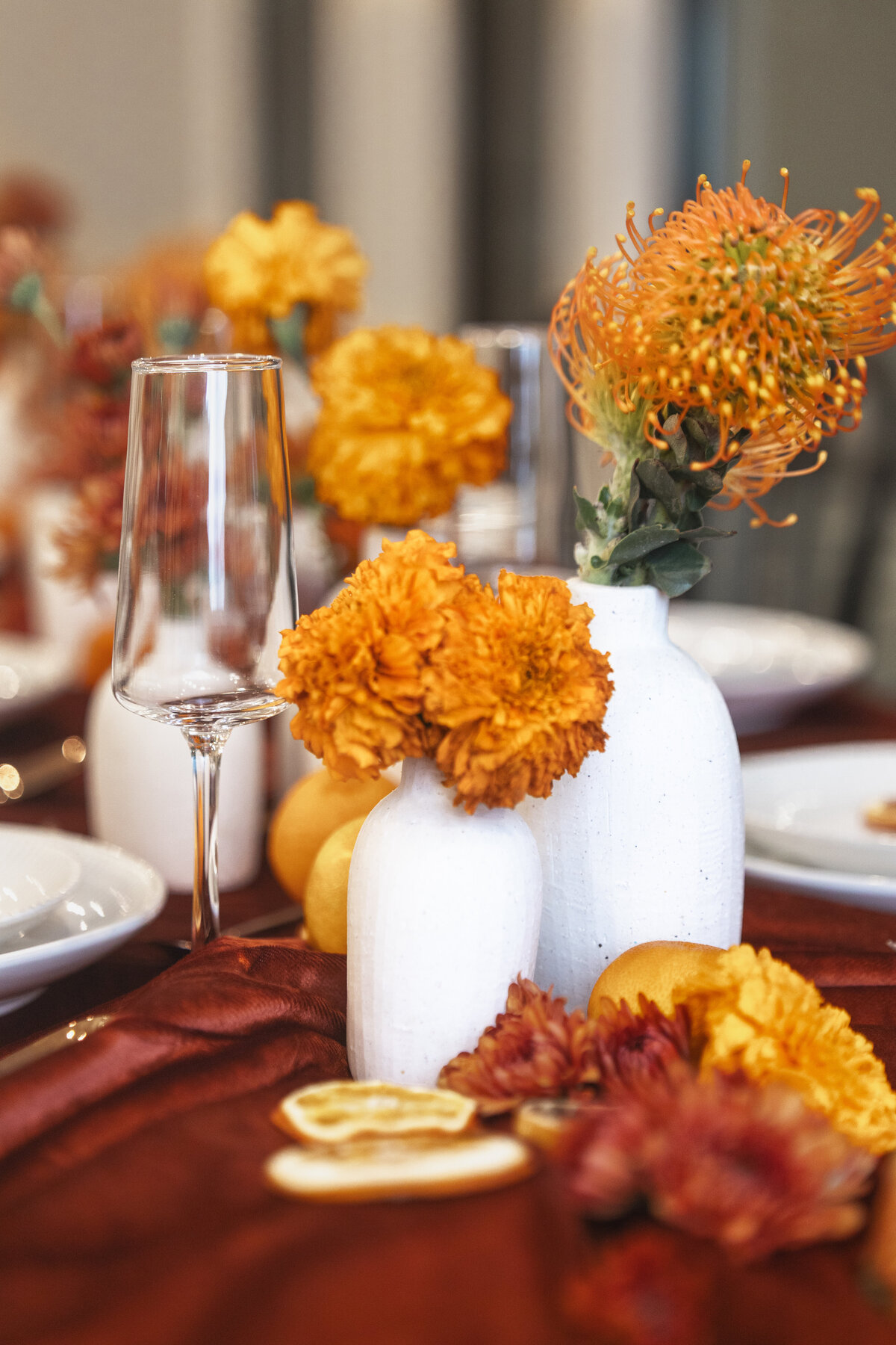 Salt Lake City wedding detail photographer showcasing a luxury fall wedding tablescape with marigold florals, textured linens, and elegant place settings. Moonlit Photo Utah wedding décor and event detail photography.