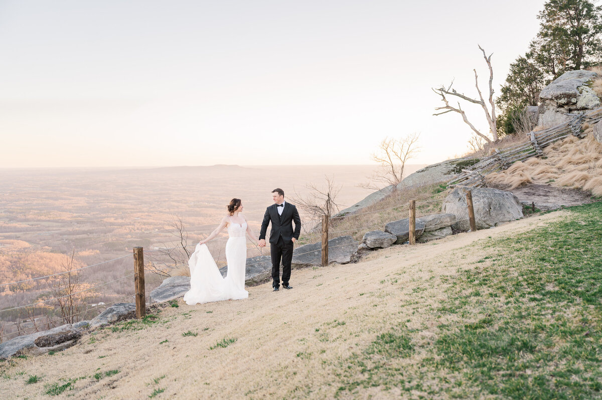 A loving couple at sunset on their wedding day on Glassy Mountain by JoLynn Photography