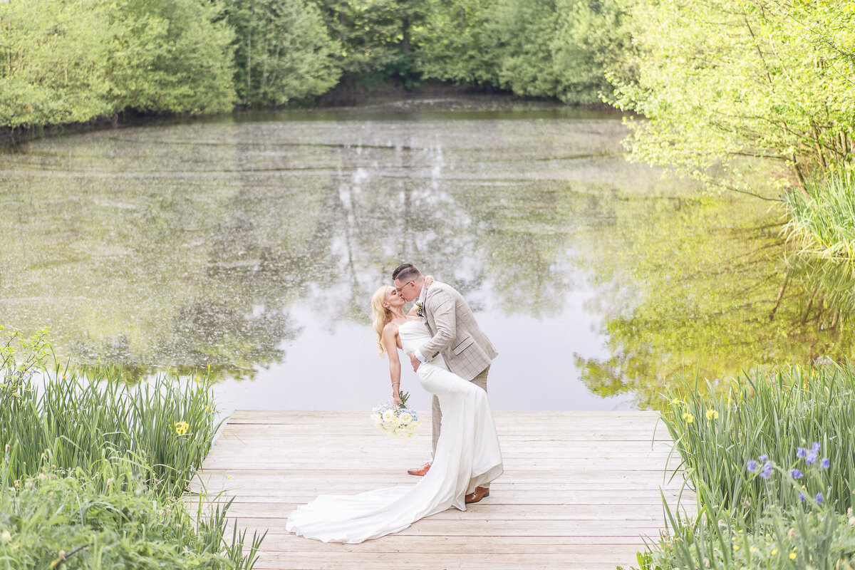 Bride and groom embracing touching foreheads in the grounds at Merrydale Manor Cheshire