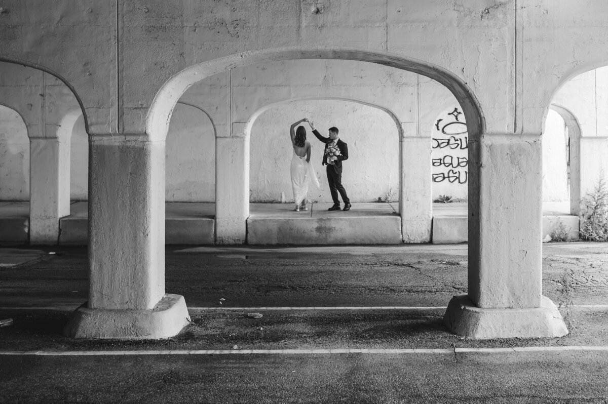 A bride and groom dance underneath  a bridge in Pilsen.