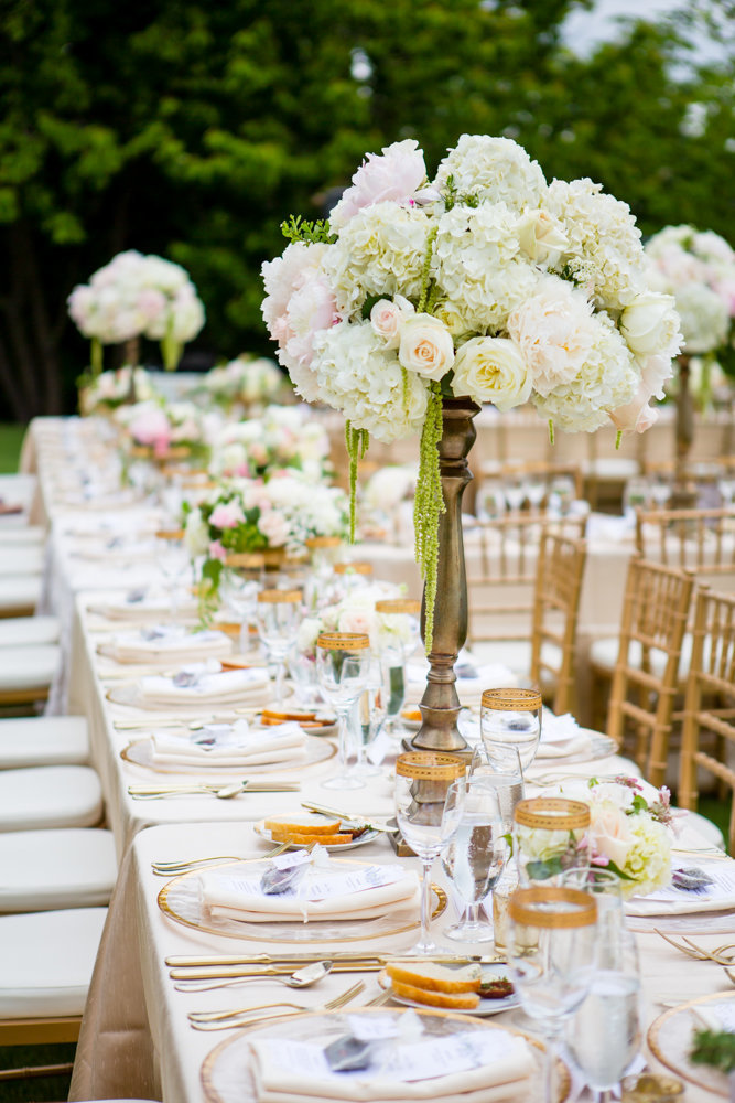 Tall garden style arrangements on  gold stands in white and blush floral.