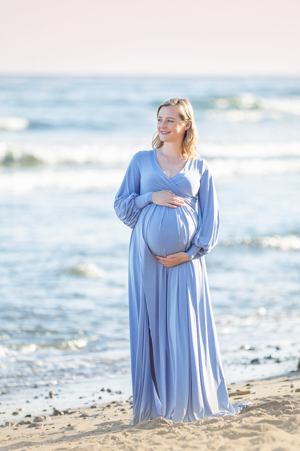Mom to be in a long blue gown awaiting her baby boy and looking into the distance - Los Angeles Maternity Photographer