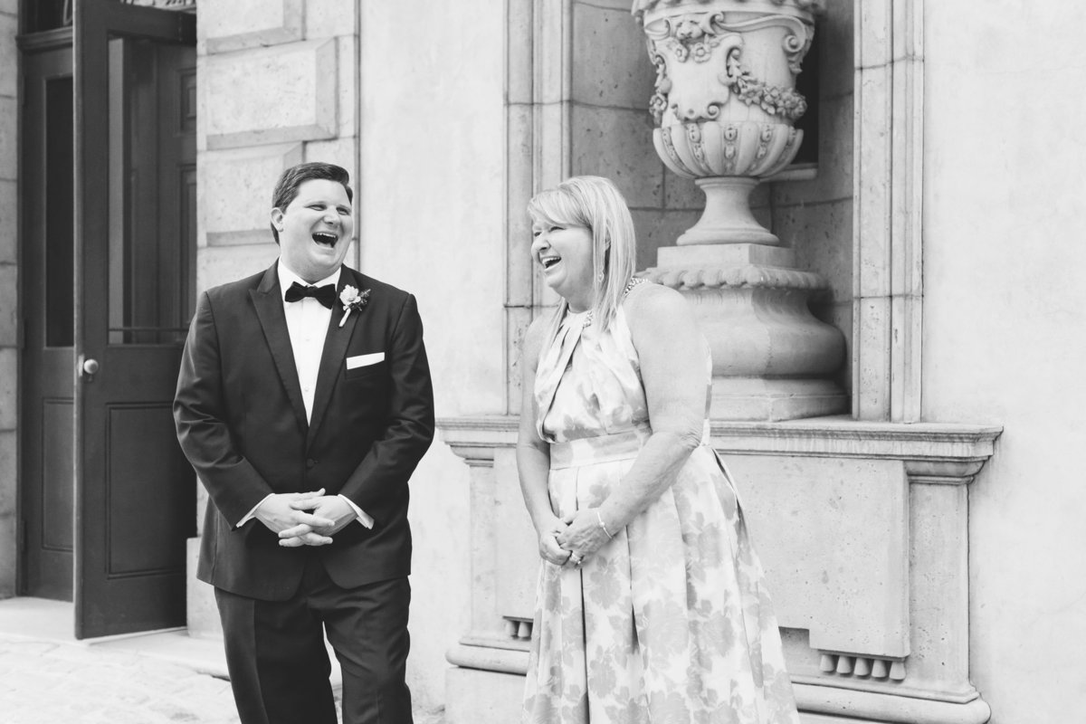The groom and his mother share a laugh during family portraits. Photo by luxury destination wedding photographer Rebecca Cerasani.