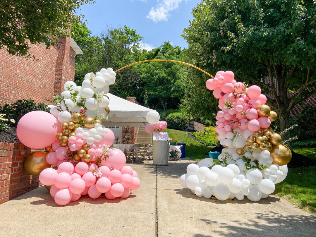 grand entrance balloon arch outdoors pink white and gold