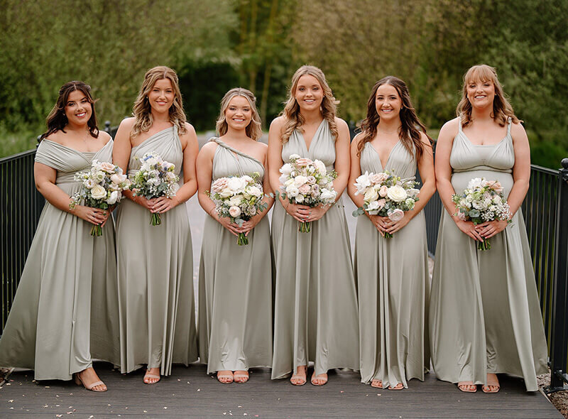 Bridesmaids holding bouquets 264