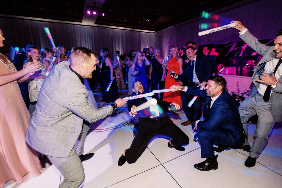 Wedding guests having a blast on the dance floor, bringing energy and excitement to this luxury wedding reception.