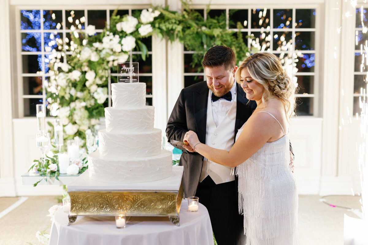 bride-and-groom-cutting-the-cake-flowers-ceremony-cake-table-flowers-ct-wedding-florist-enza-events