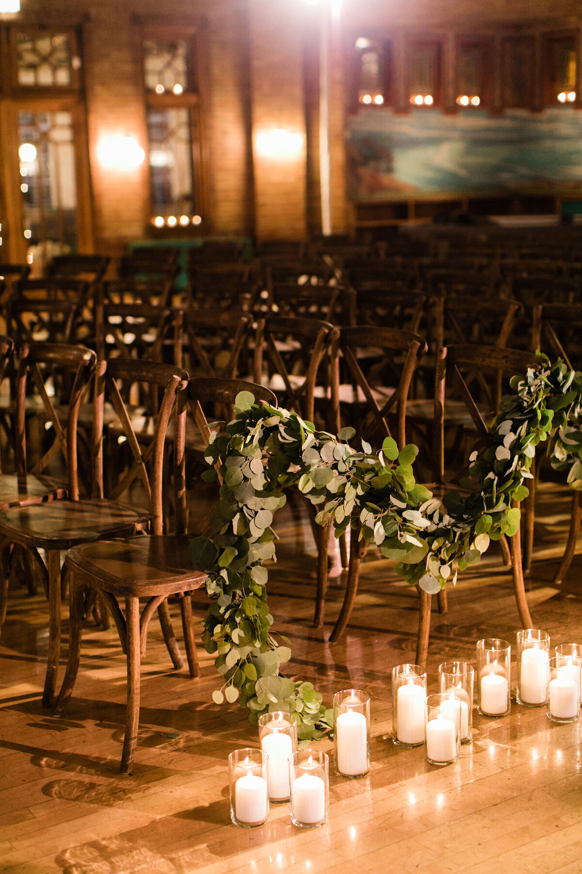 A moody and intimate wedding ceremony at Café Brauer, surrounded by candlelight.