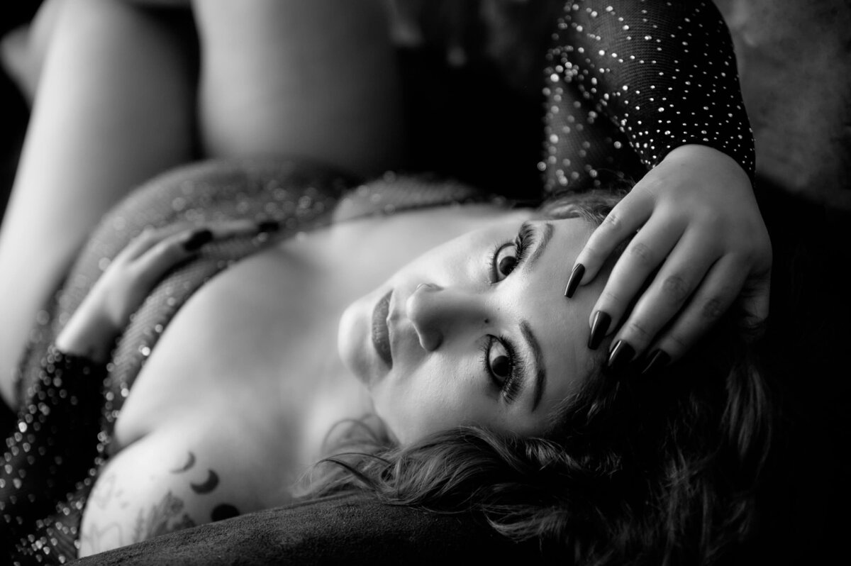 Woman starring up at the camera with her hand in her hair for her Toronto boudoir photos.