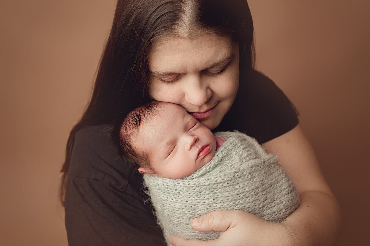 newborn portrait of mom holding her new son in rochester ny