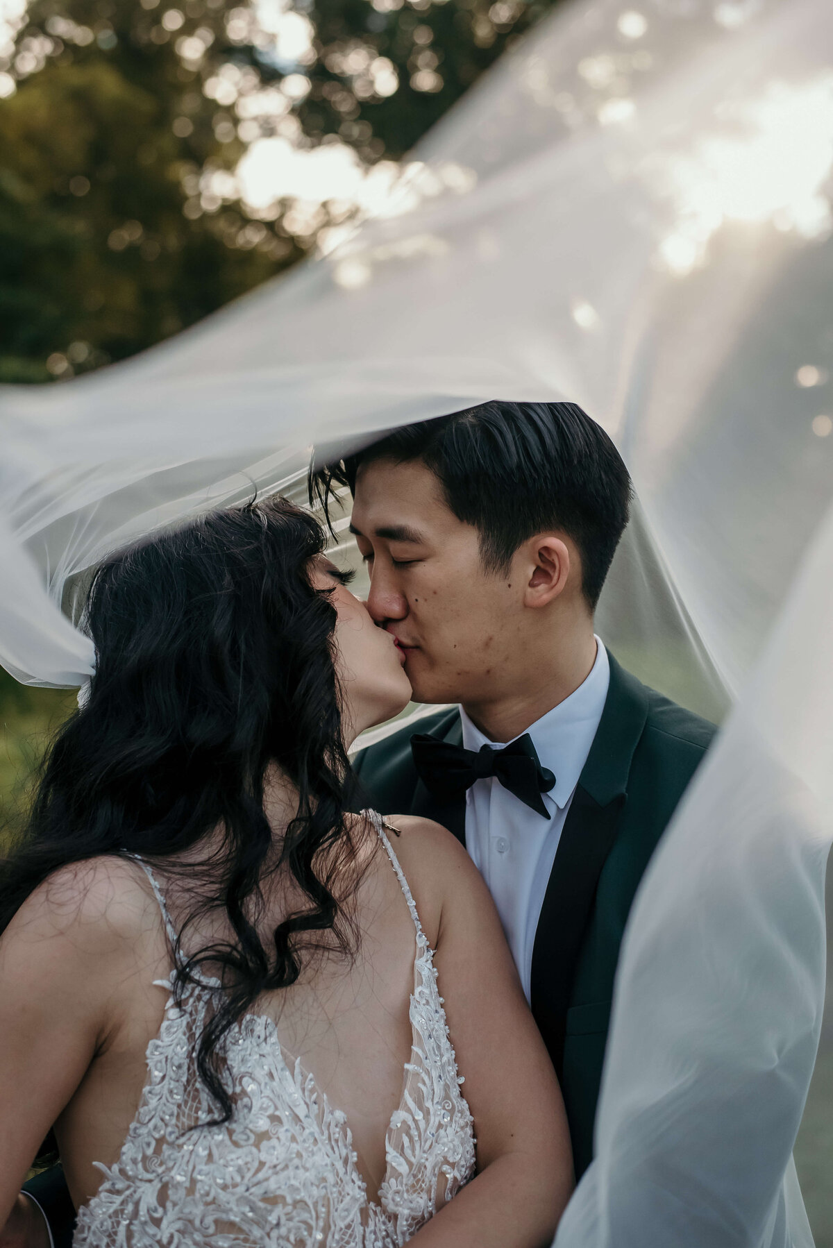 Man and woman share kiss under veil