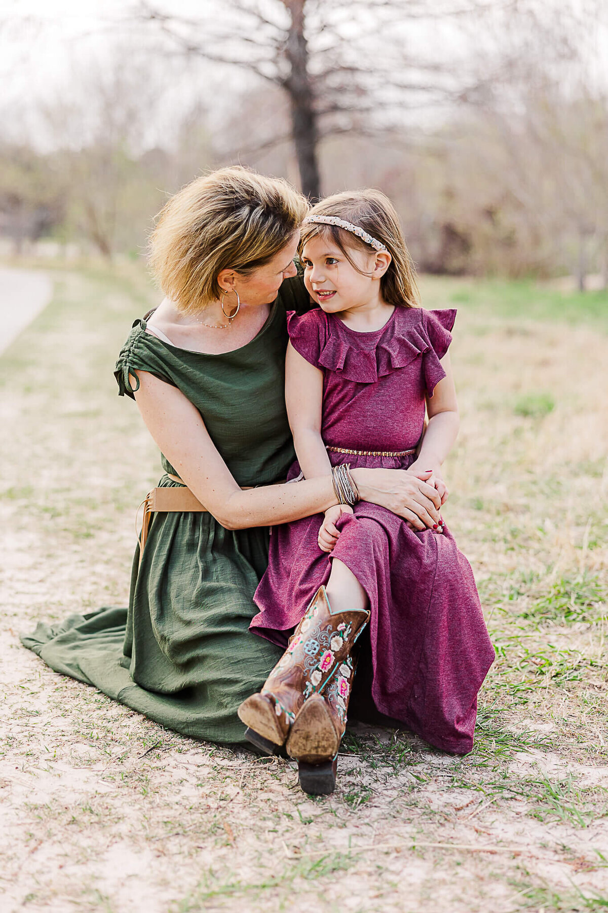 Mom and Daughter talking in green and purple dresses