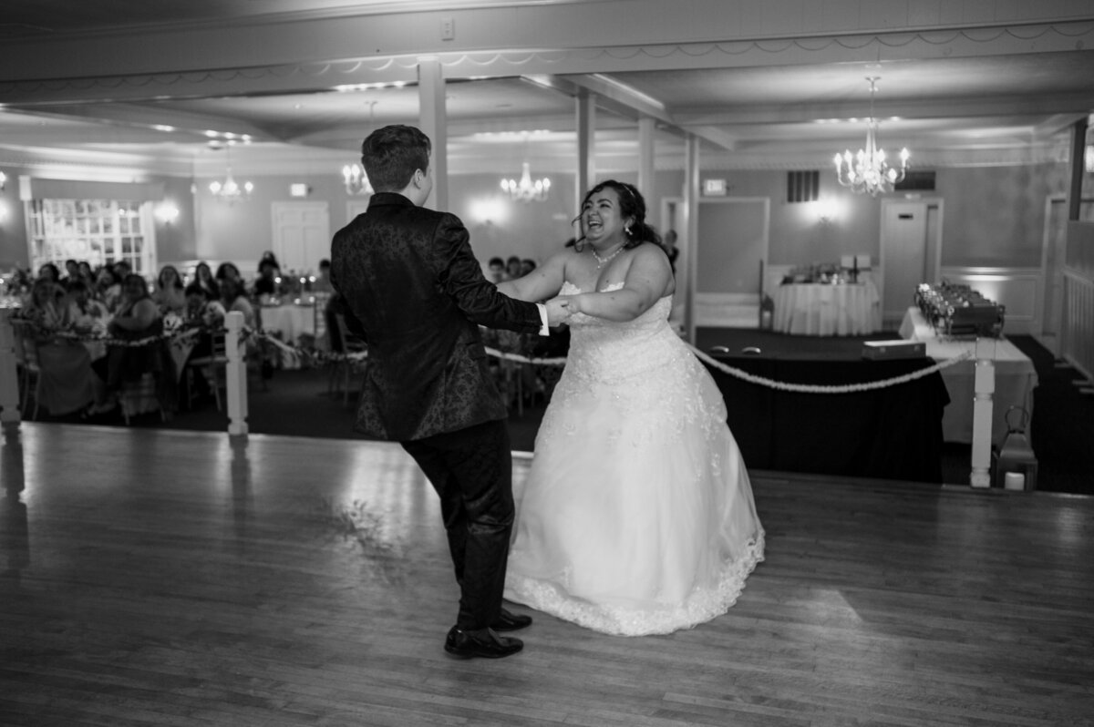 Brides smiling while dancing during their first dance