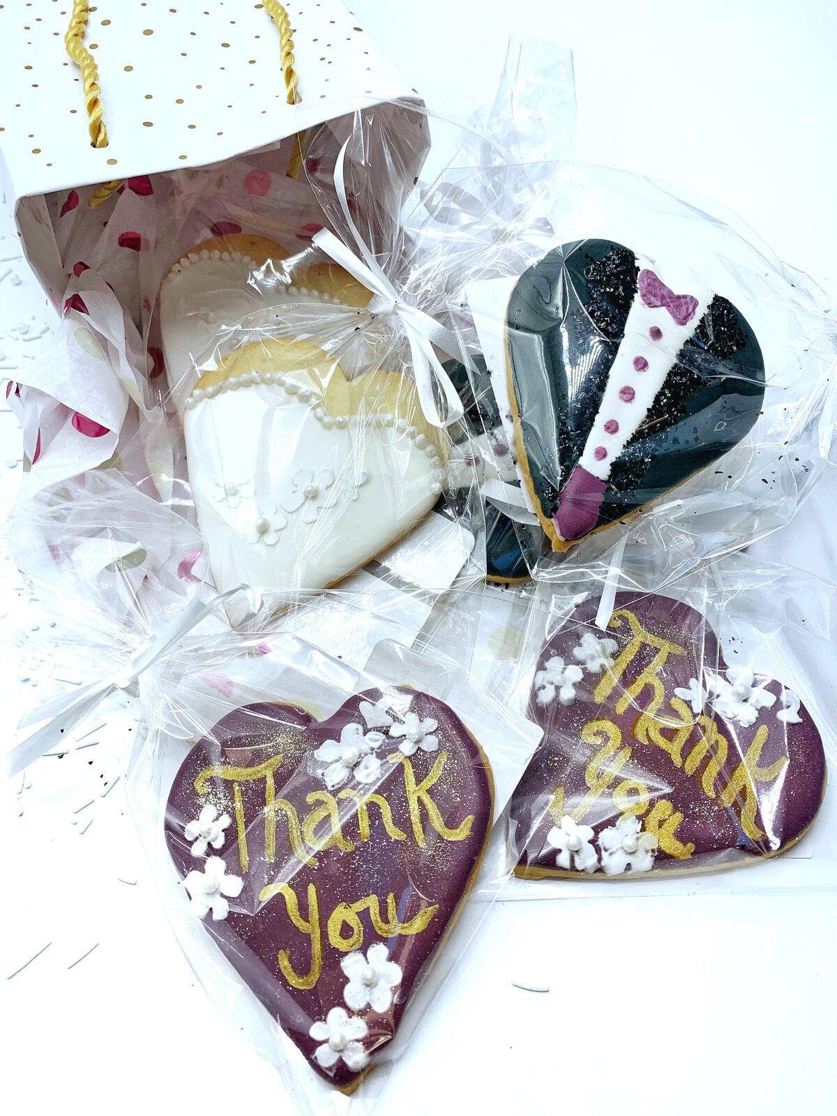Heart shaped cookies with Thank You inscription and flowers and bride and groom decorated cookie wedding favors