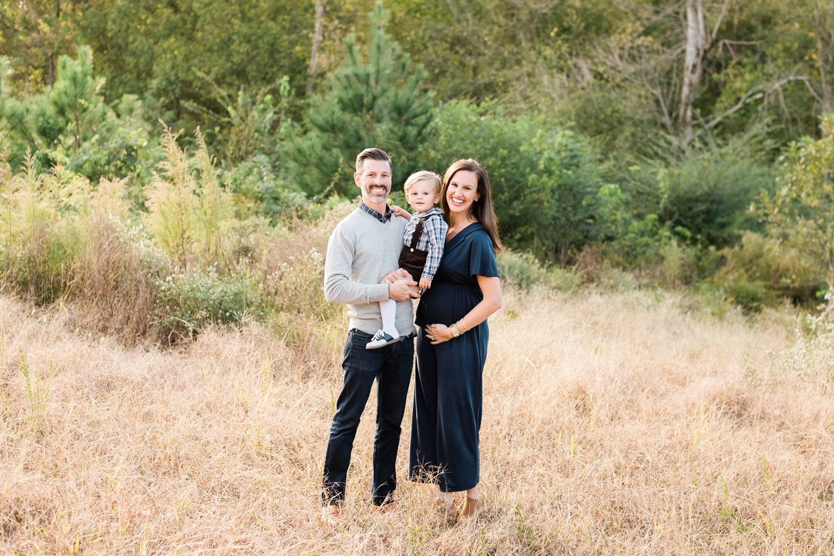 Family smiles for maternity portrait in Raleigh NC. Photographed by Raleigh NC Family Photographer A.J. Dunlap Photography.