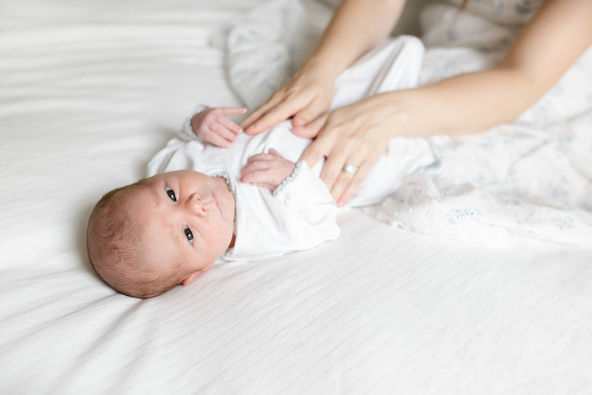 a newborn looking into destin newborn photographer camera