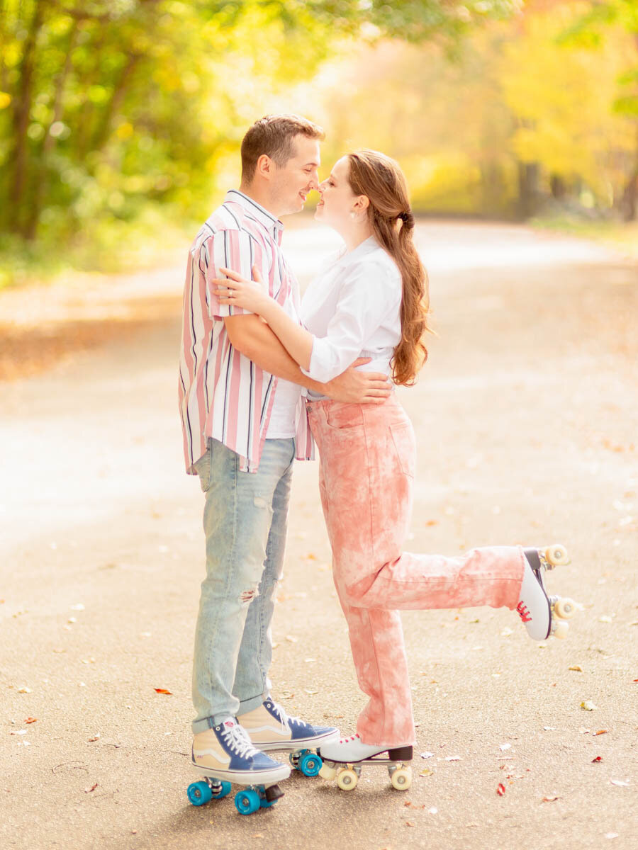 Engaged couple laugh and kiss during their retro themed engagement session.