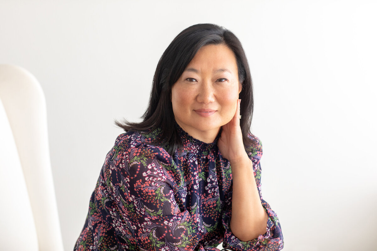 Creative entrepreneur with relaxed posture in a bright airy setting