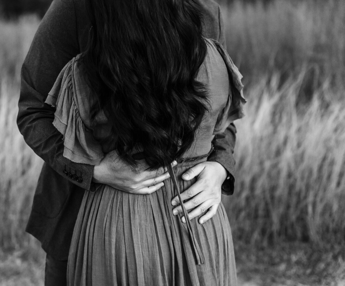Couples Photography, a man and woman embrace in a field