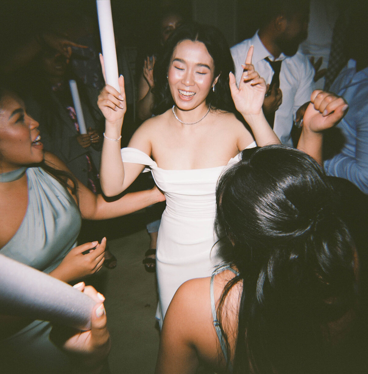 bride and bridesmaids dance at reception on film taken by boston documentary wedding photographer